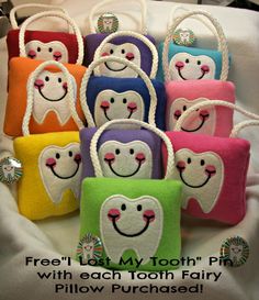 a bunch of small bags that have different designs on them, each with a smiling face