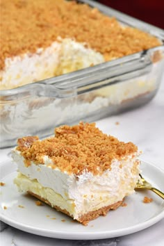 a piece of cake sitting on top of a white plate next to a glass dish