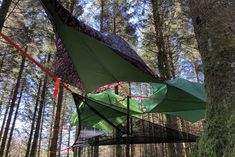 an upside down tent in the middle of a forest