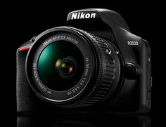 the nikon d900 digital camera with its lens up close on a black background