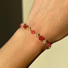 This dainty floral bracelet is handmade with individual seed beads, incorporating gold, white, and a striking shade of red to create a beautiful alternating daisy pattern. It is simple yet elegant, with the design combining several floral elements and gems, alternating in intricacy and style. This bracelet is sure to stand out without being bulky or overly dramatic. ੈ♡˳ Handmade with love and attention ੈ♡˳ Delicate selection of beads and charms, carefully and individually handpicked ੈ♡˳ Makes a Delicate Gold Beaded Friendship Bracelets, Red Flower-shaped Beaded Bracelets For Jewelry Making, Dainty Red Beaded Bracelets With Tiny Beads, Dainty Beaded Bracelet With Flower Charm, Red Beaded Dainty Bracelets, Delicate Beaded Crystal Bracelet, Handmade Delicate Rose Gold Beaded Bracelets, Handmade Delicate Rose Gold Beaded Bracelet, Delicate Handmade Rose Gold Beaded Bracelets