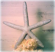 a silver starfish sitting on top of a pile of tinsel