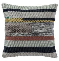 a multicolored striped pillow on a white background