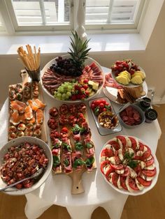 a table topped with lots of different types of fruits and veggie platters