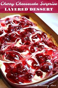 an uncooked dish with cherries and cream in it