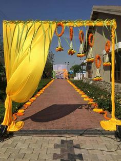 an outdoor walkway decorated with yellow and orange flowers