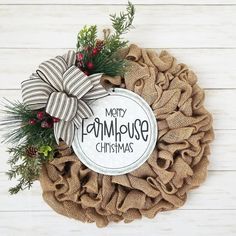 a burlock wreath with the words merry farmhouse christmas on it