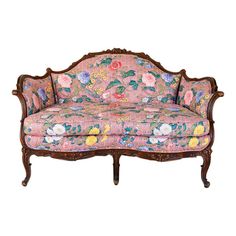 an ornately decorated couch with pink and yellow flowers on the upholstered back