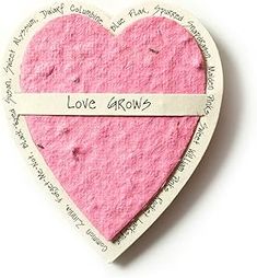 a pink heart with the words love grows written on it