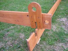 a close up of a wooden rail in the grass