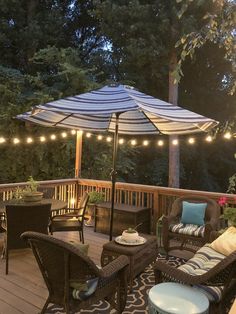 an outdoor deck with patio furniture and lights