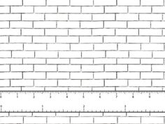 a white brick wall with a ruler in front of it that is measuring the width