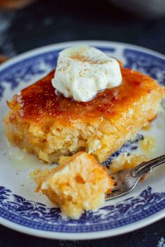 a piece of cake on a blue and white plate with a fork next to it