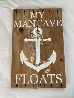 a wooden sign that says, my mancave floats with an anchor and rope on it