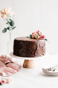 a chocolate cake sitting on top of a white table