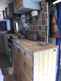 a kitchen area with wooden counter tops and tile backsplashes on the walls