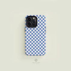 a blue and white checkerboard iphone case sitting on top of a gray surface