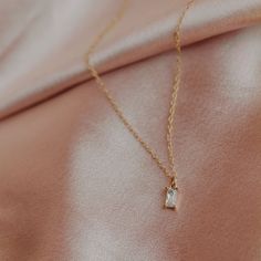 This diamond baguette necklace is sleek, sophisticated, and utterly captivating.  Crafted with precision and adorned with radiant baguette CZ diamonds, this necklace exudes timeless elegance in every facet.  Elevate your look with this exquisite piece, perfect for any occasion. Makes. Lovely bridesmaid gift. THE DETAILS: 🖤 14k gold-filled or sterling silver necklace   🖤 14-20 inches length.  (14= small choker, 15= regular choker, 16= collarbone, 18= regular, 20= long) 🖤 5x8mm Gold plated or s Bridal Party Necklace, Karma Jewelry, Baguette Necklace, Diamond Baguette, Party Necklace, Brass Charms, Layering Necklace, Cz Diamond, Baguette Diamond