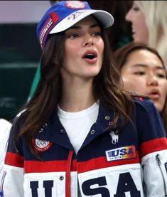 a woman wearing a usa jacket and hat