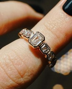 a close up of a person's hand with a ring on their finger,