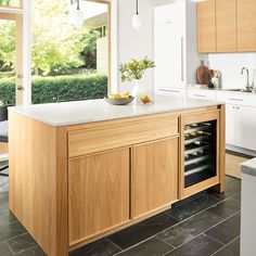 a kitchen with an island that has wine in it