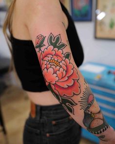 a woman with a flower tattoo on her arm