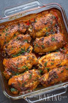 chicken in a casserole dish with herbs and seasoning on the side, ready to be eaten