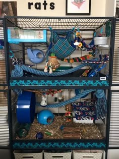 an animal cage filled with lots of toys and other items on top of each other