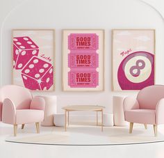 two pink chairs sitting next to each other on top of a white floor in front of posters