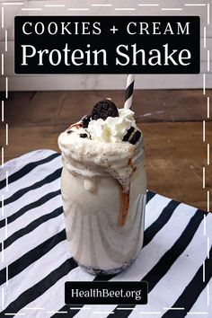 cookies and cream protein shake in a mason jar on a striped tablecloth with text overlay