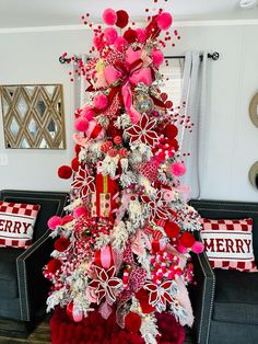 a christmas tree decorated with red, white and pink ornaments