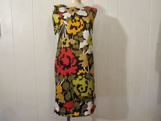 "Vintage 1960s mod dress. Made of multi color cotton. Has abstract flower pattern, back zipper and cotton lining. About a size large. Actual measurements are: 40.5\" around the bust 38\" around the waist 40.5\" around the hips 15.5\" shoulder to shoulder 37.5\" overall length In excellent unused condition. New old stock." Cotton Lined Mod Dress, Mod Style Cotton Lined Dresses, Mod Style Cotton Dress With Lining, Cotton Mod Dress With Lining, Multicolor Cotton Mod Dress, Multicolor Mod Cotton Dresses, Abstract Flower Pattern, 1960s Mod Dress, Vintage Dresses 1960s