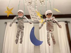 two tinkered astronauts hanging from the ceiling