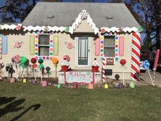 a house decorated for christmas with candy canes and lollipops on the windows