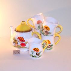 a white table topped with lots of cups and saucers