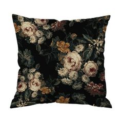 a black pillow with flowers and leaves on the front, it has a dark background