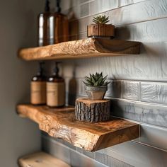 three wooden shelves with plants and soaps on them, along with other bathroom items