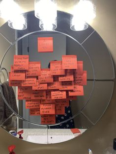 a mirror with sticky notes attached to it