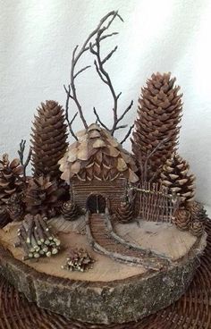 a small house made out of wood and pine cones