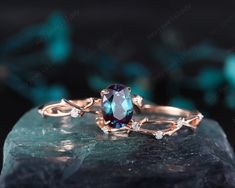 a ring with an oval blue topazte surrounded by white diamonds on a rock