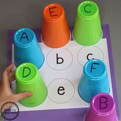 an alphabet matching game with plastic cups