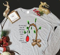 Long sleeve, 100% cotton t-shirt with Charlie Brown Christmas Tree and quote printed on chest. Christmas T-shirt With Text Print For Gifting, Christmas Gift T-shirt With Text Print, Christmas Text Print T-shirt As Gift, Christmas Text Print T-shirt Gift, Charlie Brown Christmas Quotes, Diy Christmas Shirts, Brown Christmas Tree, Charlie Brown Christmas Tree, Brown Christmas