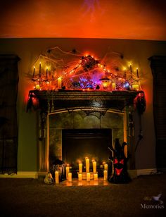 a fire place with candles and decorations on it