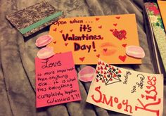 valentine's day notes are laid out on a bed with other writing and decorations