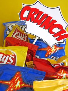 a pile of chips sitting on top of a table next to a sign that says crunch