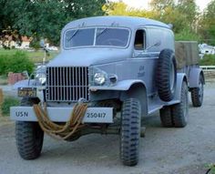 an old truck is parked on the side of the road