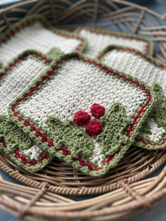 two crocheted dishcloths sitting on top of a wicker basket