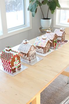 several gingerbread houses are displayed on a table