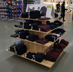 there are many shirts on display in the store