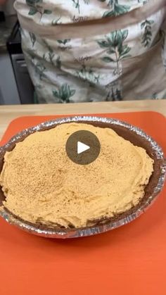 a pie sitting on top of an orange table